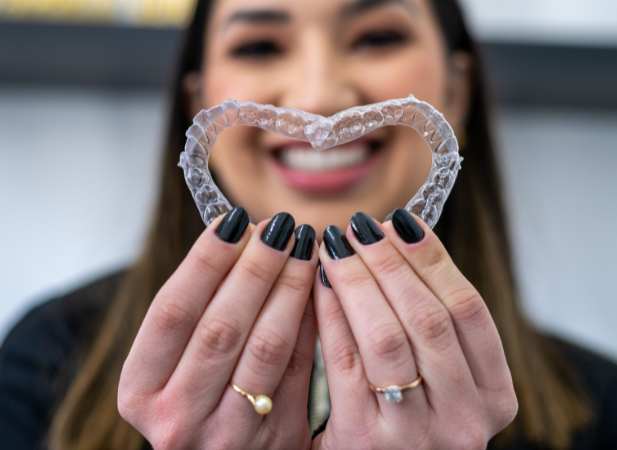 woman holding our clear braces in surprise AZ